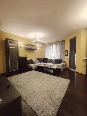 a living room with a couch and a rug at A Colorful Apart for a Start in Sofia