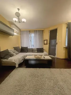 a living room with a couch and a coffee table at A Colorful Apart for a Start in Sofia