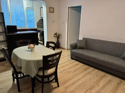 a living room with a table and a couch at Zoev in Plovdiv
