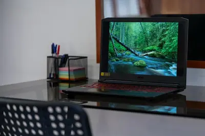 a laptop computer sitting on top of a glass table at Two Homelike Apartments by NDK and Vitosha Blvd with 2 Free Parking Spots in Sofia