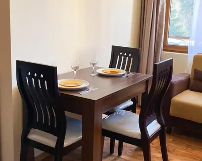 a dining room table with two chairs and two wine glasses at 