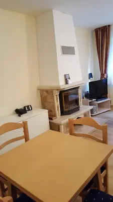 a living room with a table and a microwave at The Castle Complex - Apartment 401 in Pamporovo