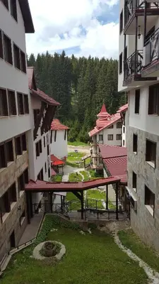 an overhead view of a picnic table in a courtyard between two buildings at The Castle Complex - Apartment 401 in Pamporovo