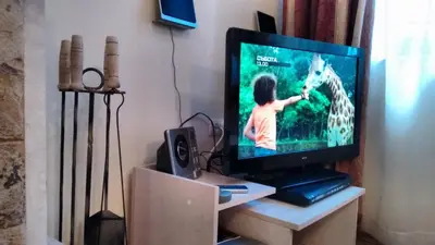 a tv sitting on a stand with a video game at The Castle Complex - Apartment 401 in Pamporovo