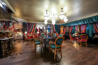 a dining room with colorful chairs and tables at Complex Baroto in Gotse Delchev