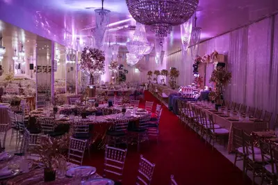 a banquet hall with tables and chairs and chandeliers at Complex Baroto in Gotse Delchev