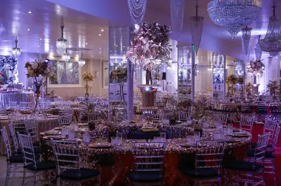 a banquet hall with tables and chairs and chandeliers at Complex Baroto in Gotse Delchev