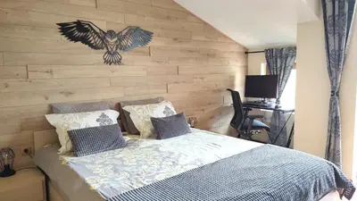 a bedroom with a bed with a wooden wall at apartment Mountain Delight, Bansko in Bansko
