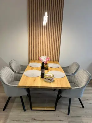 a wooden table with chairs and a bottle of wine at MidnightBlue Apartment in Bansko