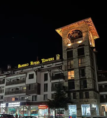 a building with a clock tower on top of it at MidnightBlue Apartment in Bansko