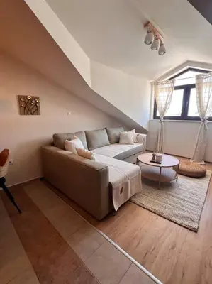 a living room with a couch and a table at Cozy 1 bedroom apartment next to the gondola in Bansko