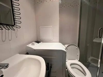 a bathroom with a sink and a toilet and a shower at Cozy 1 bedroom apartment next to the gondola in Bansko