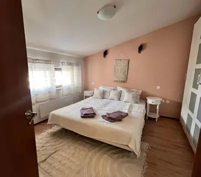 a bedroom with a large bed with two pillows on it at Cozy 1 bedroom apartment next to the gondola in Bansko