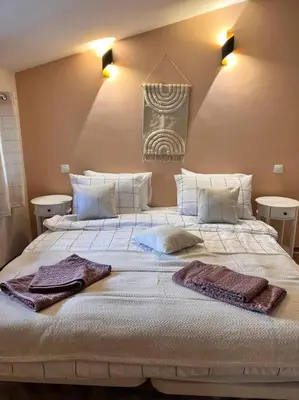 a bedroom with a large bed with towels on it at Cozy 1 bedroom apartment next to the gondola in Bansko