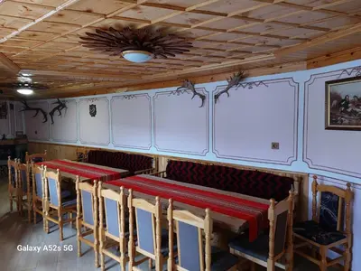 a room with a row of tables and chairs at Стаи за гости Симона in Koprivshtitsa
