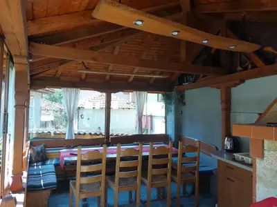 a dining room with a wooden table and chairs at Стаи за гости Симона in Koprivshtitsa