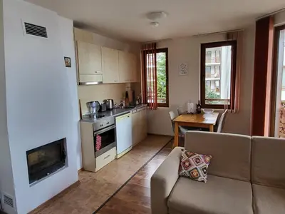 a kitchen and living room with a couch and a table at Gri's place in Bansko