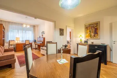 a living room with a dining table and a living room at Opera in Sofia