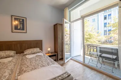 a bedroom with a bed and a large window at Urban Haven Retreat in Sofia