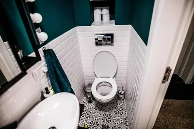 a small bathroom with a toilet and a sink at Green Flat Sofia Historic Center in Sofia