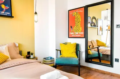 a bedroom with a mirror and a bed and a chair at 4 BDR 2 BTH Netflix Panorama Views in Sofia