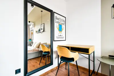 a mirror in a room with two chairs and a desk at 4 BDR 2 BTH Netflix Panorama Views in Sofia