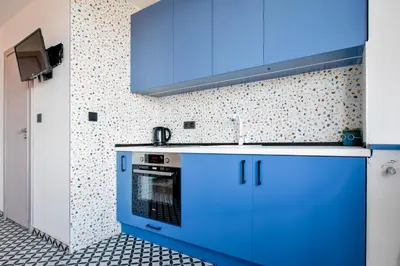 a kitchen with blue cabinets and a stove at 4 BDR 2 BTH Netflix Panorama Views in Sofia
