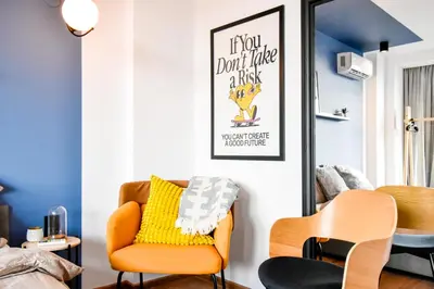 a living room with a yellow chair and a mirror at 4 BDR 2 BTH Netflix Panorama Views in Sofia