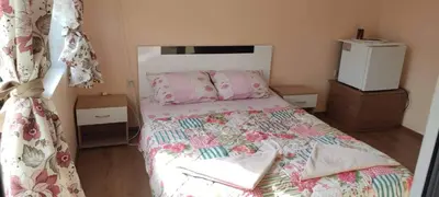 a small bedroom with a bed with a colorful comforter at Guest House Proynovi in Kalofer