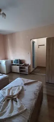 an empty room with two beds in it at Guest House Proynovi in Kalofer