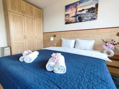a bedroom with a blue bed with towels on it at Belvedere Holiday Club К505 Sunset View in Bansko