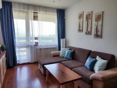 a living room with a couch and a coffee table at Belvedere Holiday Club К505 Sunset View in Bansko