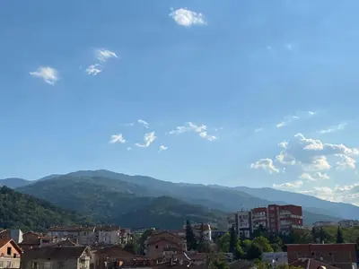 a view of a city with mountains in the background at Family Hotel 