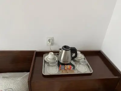 a tray with a tea kettle and glasses on a table at Family Hotel 