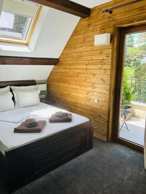 a bedroom with a bed with towels on it at Villa Ema in Panichishte