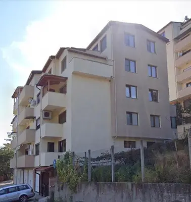 a tall building with a car parked in front of it at Apartament G&M in Sandanski