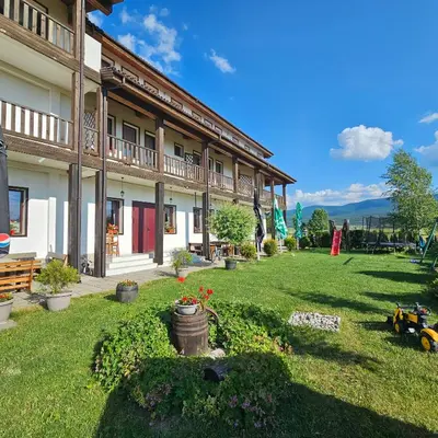 a building with a yard with plants and flowers at Guest House Belchin View in Belchin