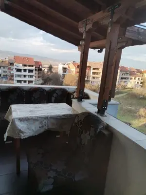 a table and chairs on a balcony with a view at Удобство in Petrich