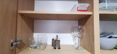 a cabinet with two wine glasses on a shelf at Sunflower in Sofia
