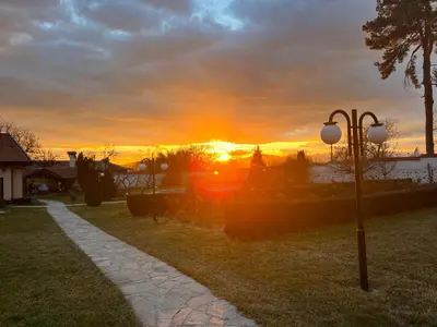 a sunset in a field with a street light at Vila Teo in Vasil Levski