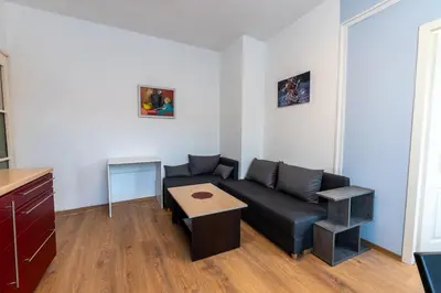 a living room with a couch and a table at 3-BR Central Residence in Sofia