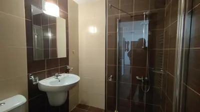 a bathroom with a shower and a sink and a toilet at Bansko Ski Apartments in Bansko Royal Towers in Bansko