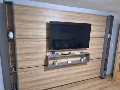 a living room with a flat screen tv on a wall at Apart 8 in Sandanski