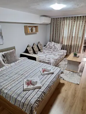 two beds in a room with towels on them at Apart 8 in Sandanski