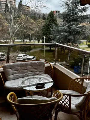 a balcony with a couch and a table and chairs at Sunny Park Retreat in Sandanski