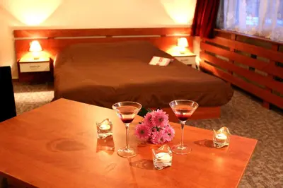 a hotel room with two glasses of wine on a table at Hotel of Bulgarian Academy of Sciences in Sofia