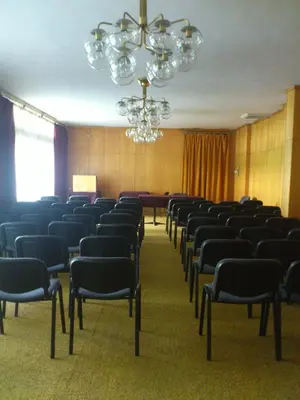 a conference room with chairs and a chandelier at Hotel of Bulgarian Academy of Sciences in Sofia