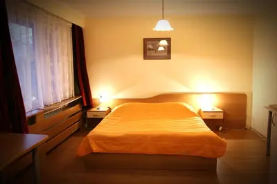 a bedroom with a bed and two night lights at Hotel of Bulgarian Academy of Sciences in Sofia