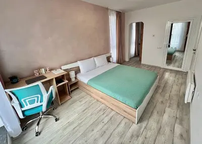 a bedroom with a bed and a desk and a chair at Rio Apart Deluxe in Sofia