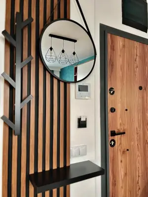 a mirror hanging on a wall next to a door at Rio Apart Deluxe in Sofia